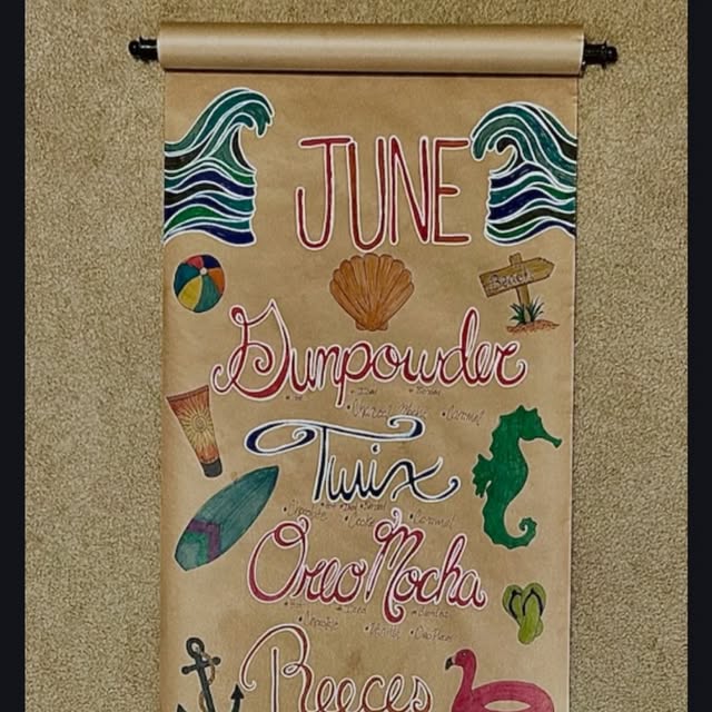 Hand-drawn beach-themed specialty flavor board listing flavors like Gunpowder, Twix, and Oreo Mocha